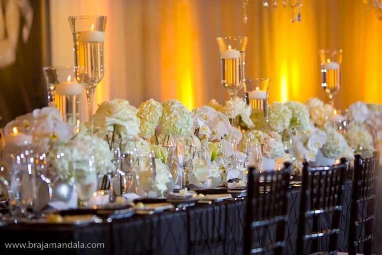 White flower arrangements at the center of a wedding table