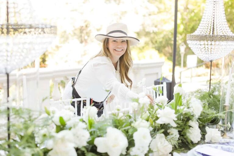Jennifer Cole checking the flower arrangements for a wedding venue