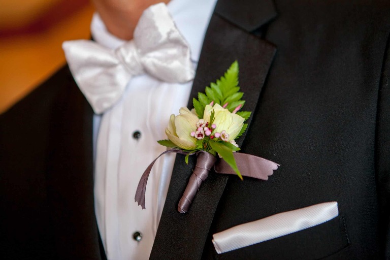 A boutonnière pinned on the groom's suit